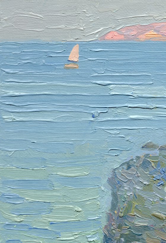 A lonely white sail gleams