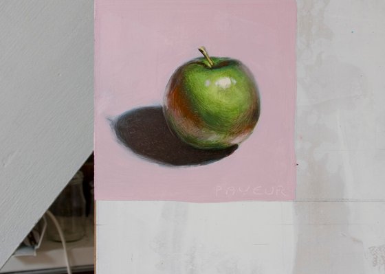 green apple on pink background