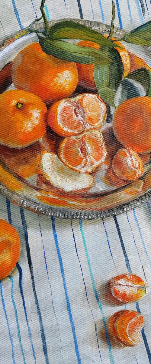 Clementines on stripen tablecloth by Leyla Demir