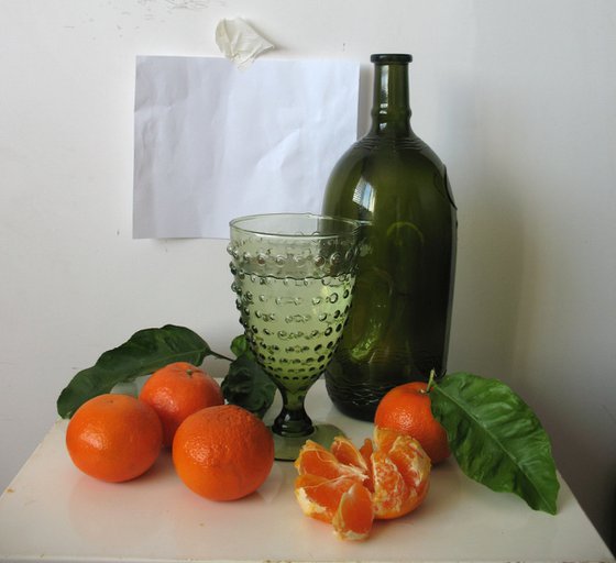 Still life with a green bottle and tangerines