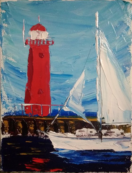 Sailing yacht and the red lighthouse