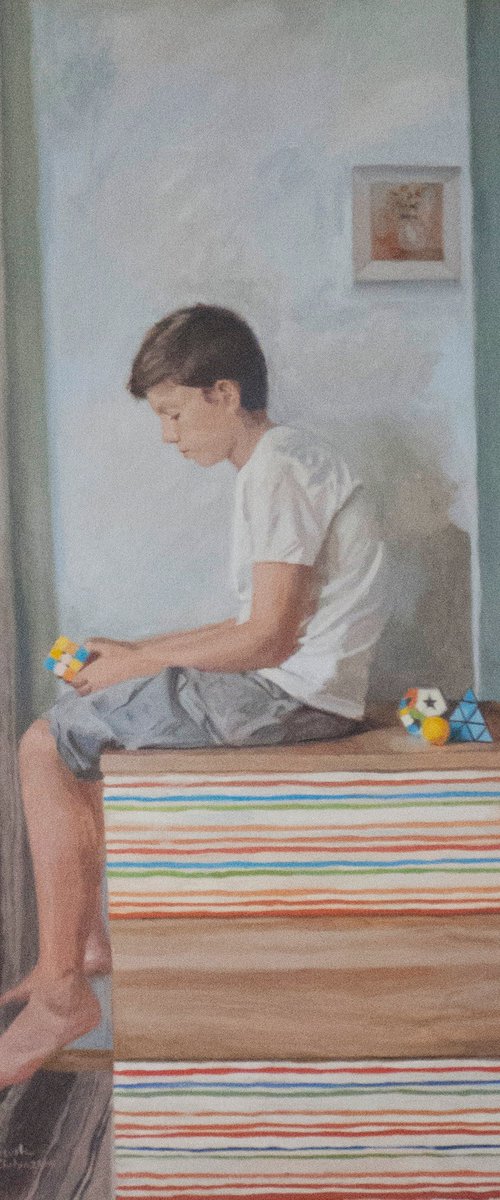 Boy playing Rubik cube by Radosveta Zhelyazkova