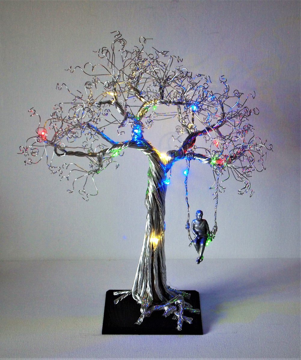 Silver wire tree sculpture with swing, boy and LED lights by Steph Morgan