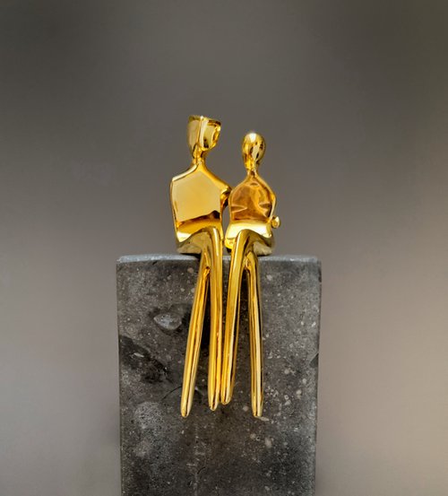 "Caress" a small  gold-plated bronze sculpture of a loving couple by Yenny Cocq