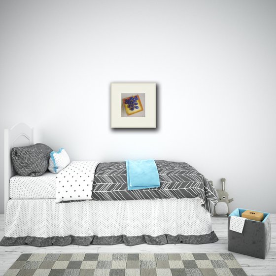 Blue plums on a yellow dish