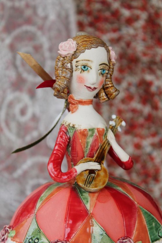 Girl with a mandolin. Sculptured bell-doll