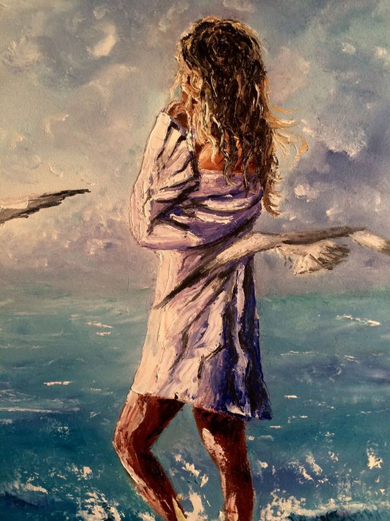 Girl with the seagulls at the beach