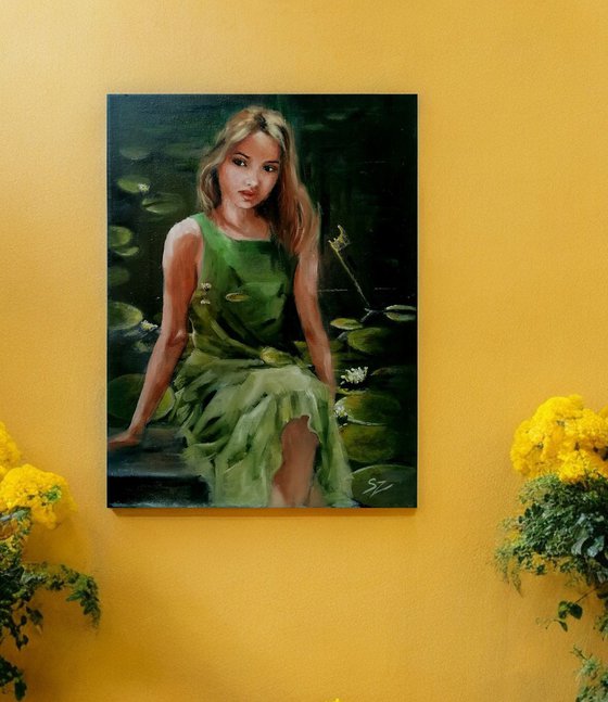 Girl sitting  by the pond