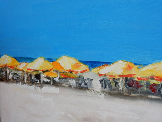At the beach. yellow umbrellas.