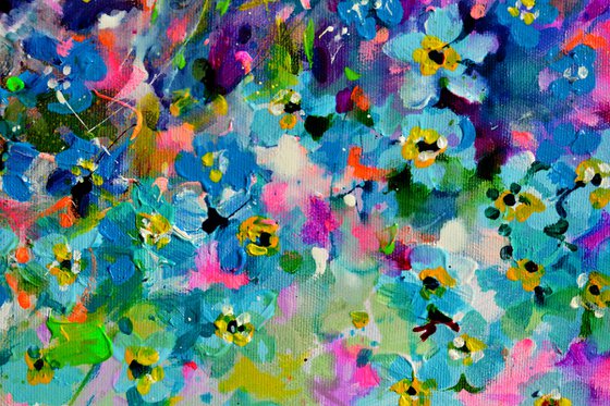 Forget me not flower field at sunrise