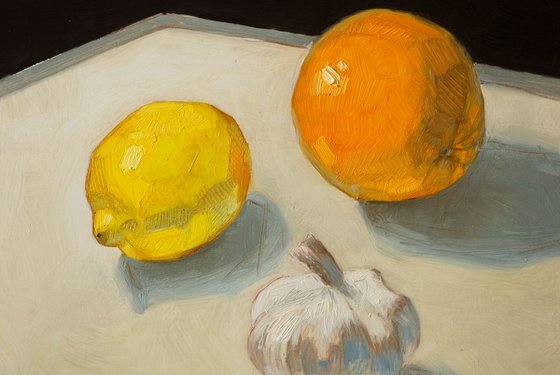 large modern still life of yellow lemons, orange and unexpected garlic