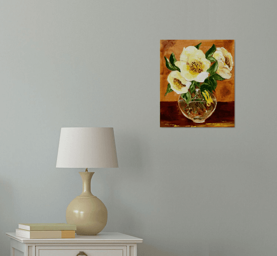 Bouquet of wild yellow roses in a vase on wooden table.