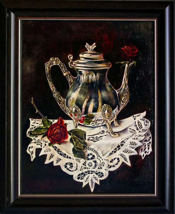 Silver coffee pot with roses on a lace doily