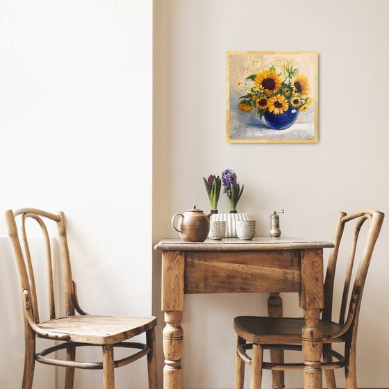 Sunflowers bouquet in a blue glass vase still life