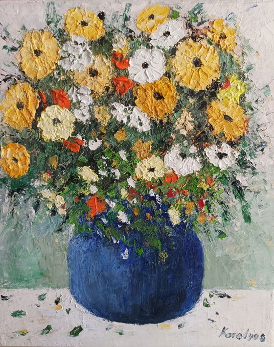 Yellow flowers in a blue vase