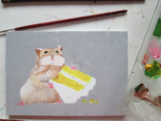 Hamster snacking on cake