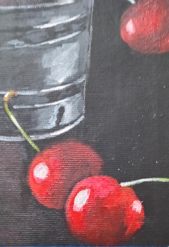 Red cherries in a metal cup