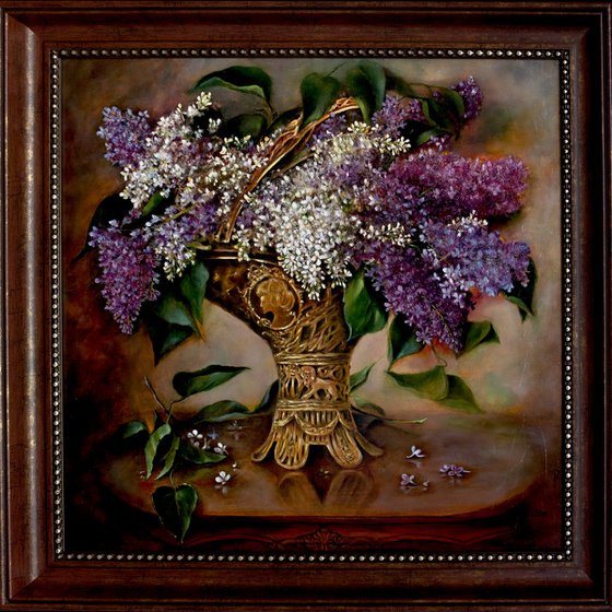 A bouquet of lilacs in a bronze vase