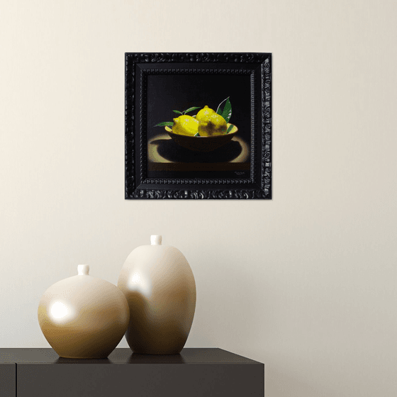 Cup with lemons in chiaroscuro