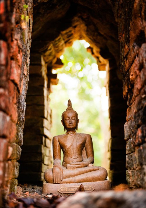 Buddha in temple ruin by Tom Hanslien