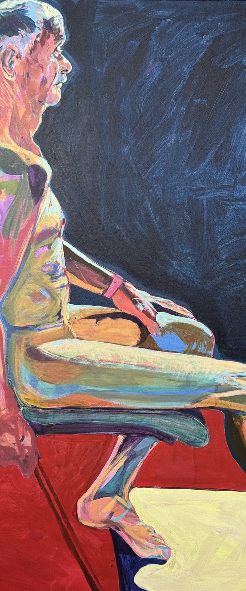Seated Chap in dark blue room by Hanna Bell