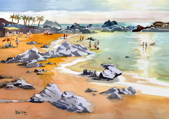 Lanzarote, The Beach at Puerto del Carmen. Sea, rocks, palm trees & sunbathers.