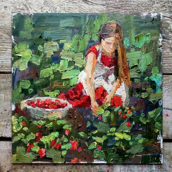 Girl picks strawberries