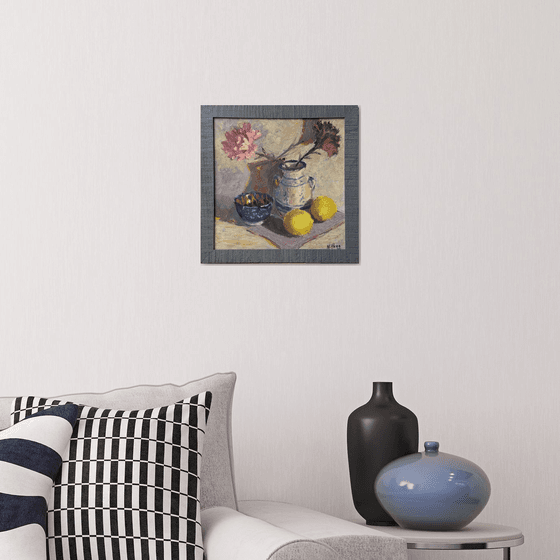 Lemons and flowers with a vase