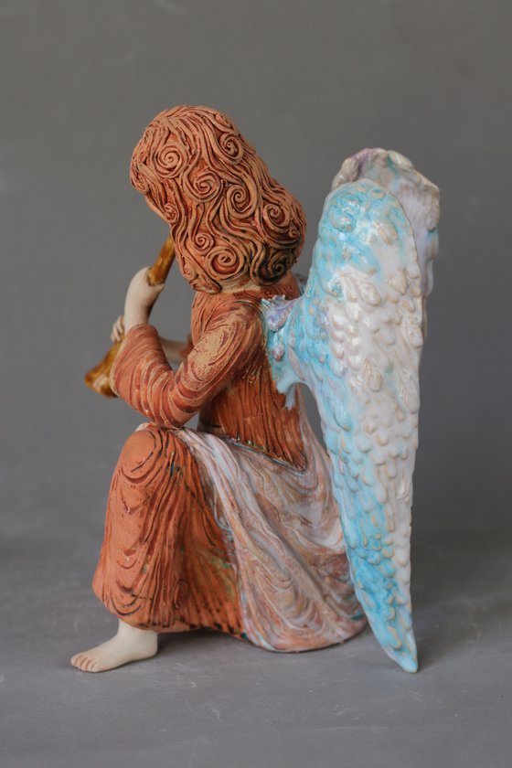 Sitting Angel with a flute. Ceramic OOAK sculpture.