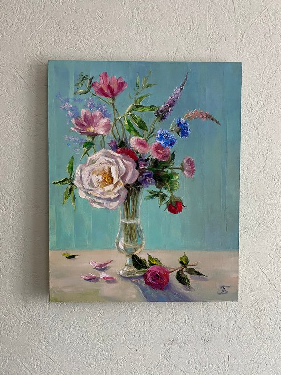 Still life with flowers. Turquoise background.