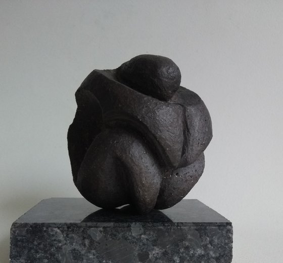 Crouching figure, protection in stone.