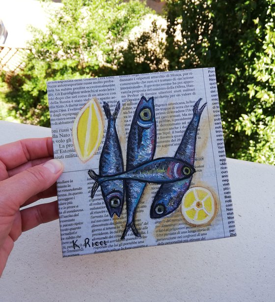 Fishes with Lemon on Newspaper