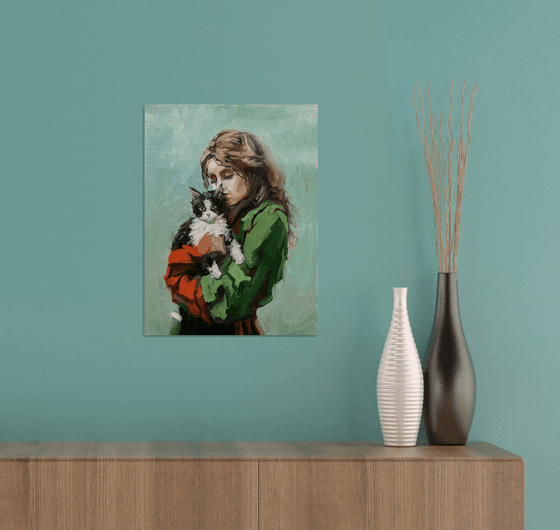 Girl in green dress with cat.