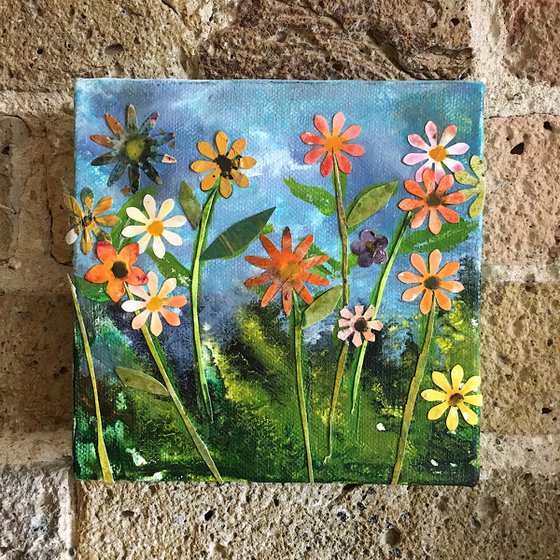 Flower meadow on blue canvas