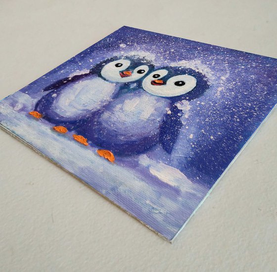 Two penguins painting