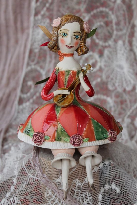 Girl with a mandolin. Sculptured bell-doll