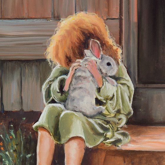Lovely little girl hugging a bunny