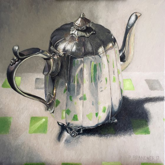Teapot on green square cloth