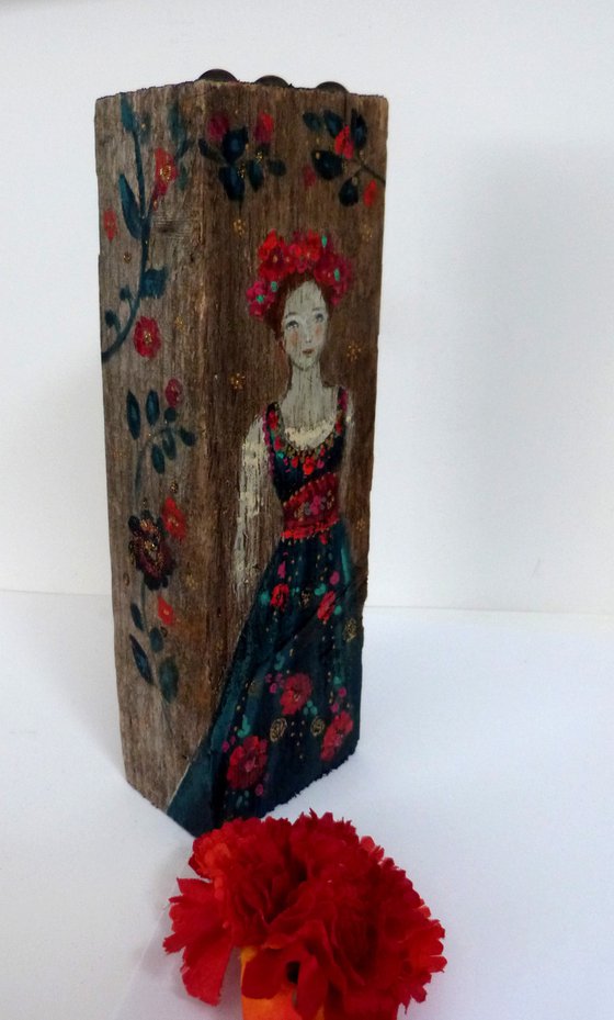 Totem sculpture Slavic woman on painted wood.