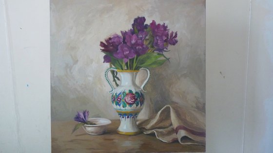 Purple flowers in a colorful jug