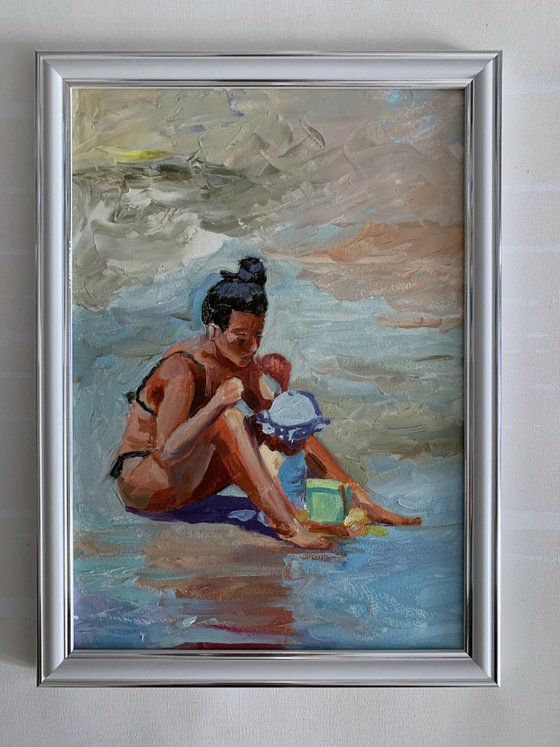 Mom with a kid on the beach.