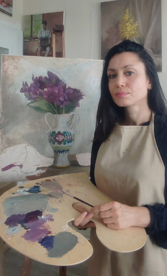 Purple flowers in a colorful jug