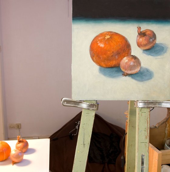 modern still life pumpkin and onions