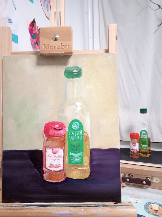 Still life with a bottle of olive oil and paprika