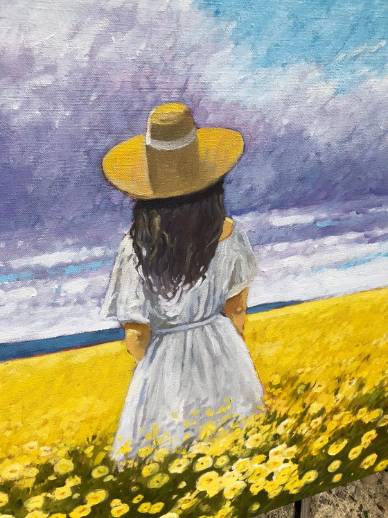 Summer. Woman in flower field