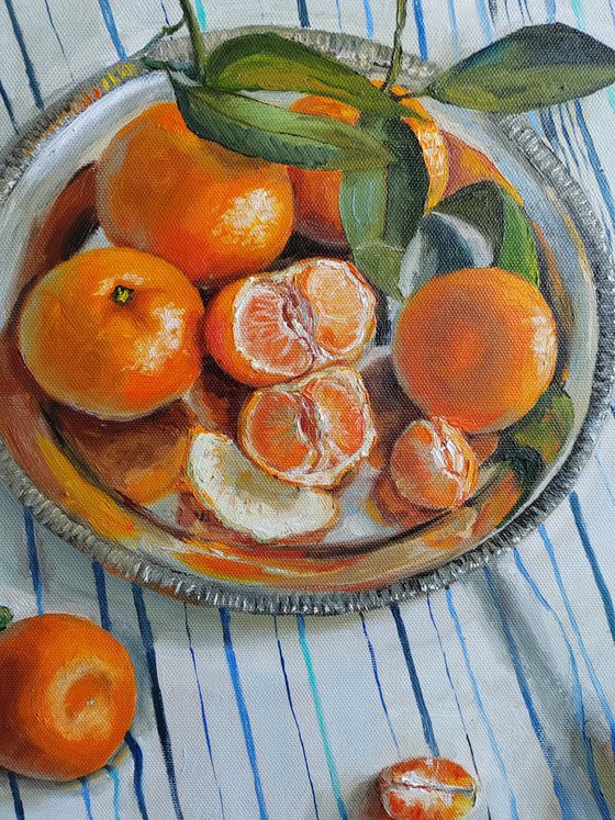 Clementines on stripen tablecloth