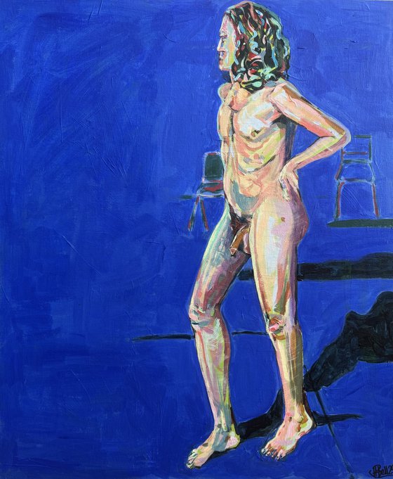 Young nude man in blue room