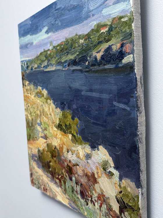 Riverbank Under Summer Sky