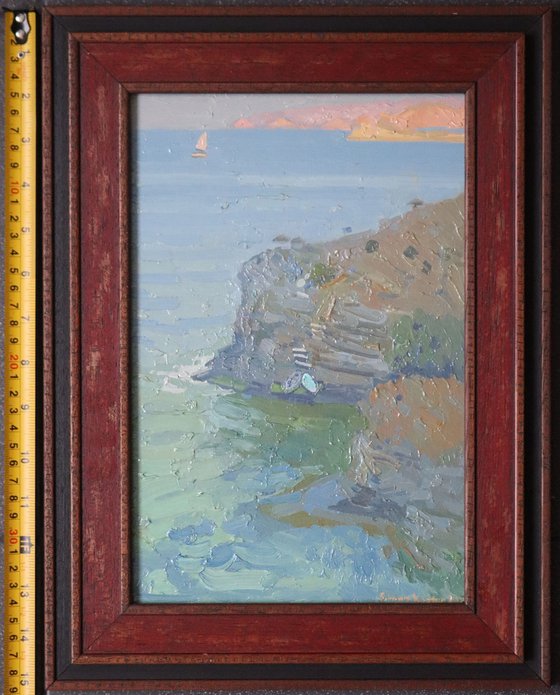 A lonely white sail gleams