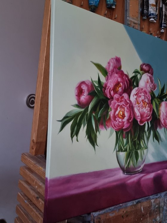 An armful of pink peonies.